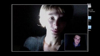 Movie still from “V/H/S” (2012), directed by Joe Swanberg – A young man is smiling for the camera while a younger man looks on; Close Up shot, High angle