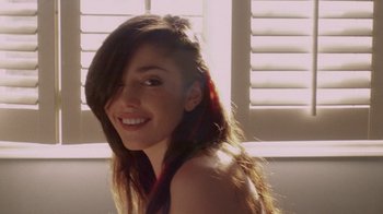Movie still from “V/H/S Viral” (2014), directed by Aaron Moorhead – A woman with long brown hair smiles for the camera; Close Up shot, Over the shoulder angle