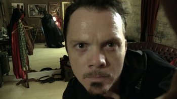 Movie still from “V/H/S Viral” (2014), directed by Aaron Moorhead – A person wearing a black shirt; Close Up shot, High angle