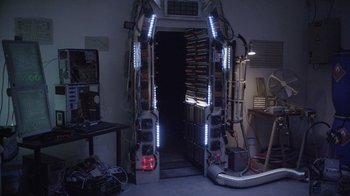 Movie still from “V/H/S Viral” (2014), directed by Aaron Moorhead – A room with a bunch of lights on the wall; Wide shot, High angle