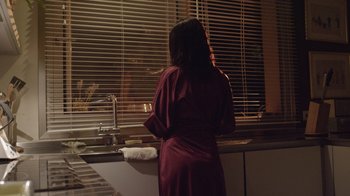 Movie still from “V/H/S Viral” (2014), directed by Aaron Moorhead – A woman standing in front of a sink looking out the window; Medium shot, Low angle
