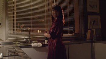 Movie still from “V/H/S Viral” (2014), directed by Aaron Moorhead – A woman standing in front of a kitchen sink; Medium shot, Over the shoulder angle