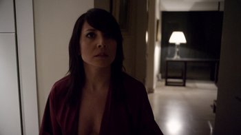 Movie still from “V/H/S Viral” (2014), directed by Aaron Moorhead – A woman in a red shirt is standing in a dark room; Close Up shot, Over the shoulder angle