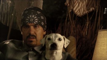 Movie still from “V/H/S Viral” (2014), directed by Aaron Moorhead – A man and a white dog sitting next to each other; Close Up shot, Over the shoulder angle