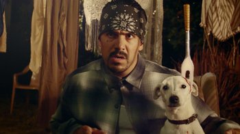 Movie still from “V/H/S Viral” (2014), directed by Aaron Moorhead – A man and a dog are posing for a picture; Medium shot, Over the shoulder angle