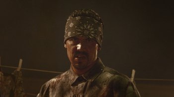 Movie still from “V/H/S Viral” (2014), directed by Aaron Moorhead – A man with a bandanna on his head; Close Up shot, Low angle