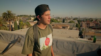 Movie still from “V/H/S Viral” (2014), directed by Aaron Moorhead – A man standing on top of a building looking at the sky; Medium shot, Low angle