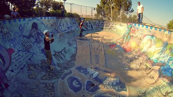 Movie still from “V/H/S Viral” (2014), directed by Aaron Moorhead – Two skateboarders at the top of a skateboard ramp; Extreme Wide shot, High angle