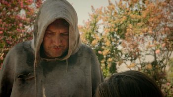 Movie still from “V/H/S Viral” (2014), directed by Aaron Moorhead – A man in a hooded sweatshirt is looking at a child; Close Up shot, Over the shoulder angle