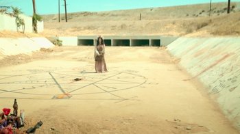 Movie still from “V/H/S Viral” (2014), directed by Aaron Moorhead – A woman standing in the middle of an empty road; Extreme Wide shot, High angle