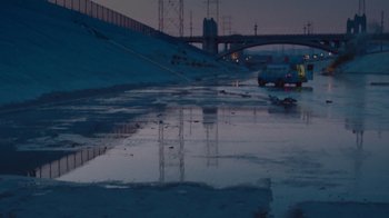 Movie still from “V/H/S Viral” (2014), directed by Aaron Moorhead – Cars parked on the side of a road near a bridge; Extreme Wide shot, High angle