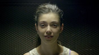 Movie still from “V/H/S Viral” (2014), directed by Aaron Moorhead – A young woman is smiling for the camera; Close Up shot, Low angle