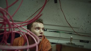 Movie still from “V/H/S Viral” (2014), directed by Aaron Moorhead – A young man looking up at the ceiling of a room; Close Up shot, Low angle
