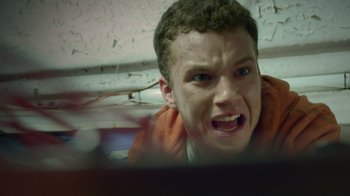 Movie still from “V/H/S Viral” (2014), directed by Aaron Moorhead – A young man is looking at the camera with an angry look on his face; Close Up shot, Low angle