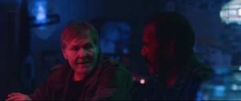 Movie still from “VFW” (2019), directed by Joe Begos – Two men are talking in the dark at night; Close Up shot, Over the shoulder angle