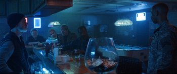 Movie still from “VFW” (2019), directed by Joe Begos – People are sitting at a bar with a glass of beer; Medium shot, Over the shoulder angle