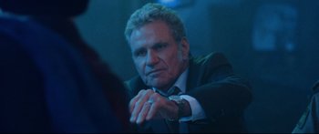 Movie still from “VFW” (2019), directed by Joe Begos – A man in a suit and tie sitting in front of a mirror; Close Up shot, Over the shoulder angle