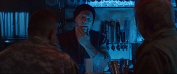 Movie still from “VFW” (2019), directed by Joe Begos – A man sitting at a bar in a dark room; Medium shot, Over the shoulder angle