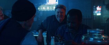 Movie still from “VFW” (2019), directed by Joe Begos – A group of people sitting around a table; Medium shot, Over the shoulder angle