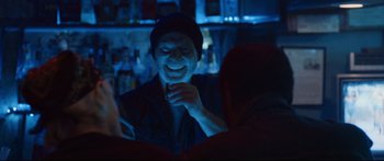 Movie still from “VFW” (2019), directed by Joe Begos – A man sitting at a table in front of a bar; Close Up shot, Over the shoulder angle