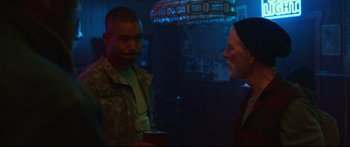 Movie still from “VFW” (2019), directed by Joe Begos – Two men are standing in a room talking to each other; Medium shot, Over the shoulder angle
