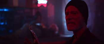 Movie still from “VFW” (2019), directed by Joe Begos – An old man is holding a guitar in a dark room; Close Up shot, Over the shoulder angle