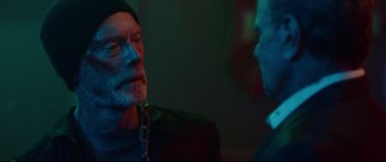 Movie still from “VFW” (2019), directed by Joe Begos – A man with a beard is talking to another man; Close Up shot, Over the shoulder angle