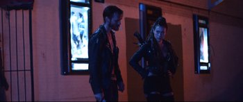 Movie still from “VFW” (2019), directed by Joe Begos – A man and a woman wearing leather jackets; Medium shot, Over the shoulder angle