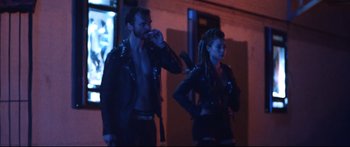 Movie still from “VFW” (2019), directed by Joe Begos – A man and a woman standing next to each other; Medium shot, Over the shoulder angle