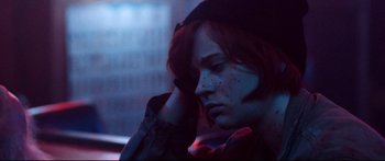 Movie still from “VFW” (2019), directed by Joe Begos – A person with red hair and a hat is sitting in a car; Close Up shot, Low angle