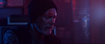Movie still from “VFW” (2019), directed by Joe Begos – A person wearing a hat with blood all over his face; Close Up shot, Low angle