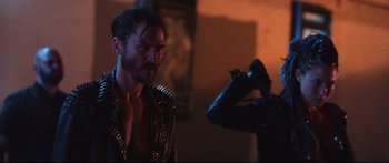 Movie still from “VFW” (2019), directed by Joe Begos – A man in a leather jacket is looking at another man in a leather jacket; Close Up shot, Over the shoulder angle