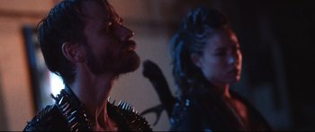 Movie still from “VFW” (2019), directed by Joe Begos – A man and a woman are standing next to each other; Close Up shot, Low angle