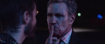 Movie still from “VFW” (2019), directed by Joe Begos – A man in a suit and tie with blood all over his face; Close Up shot, Over the shoulder angle