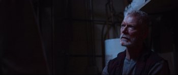 Movie still from “VFW” (2019), directed by Joe Begos – An older man is looking at something in the dark; Close Up shot, Low angle