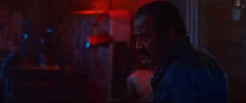 Movie still from “VFW” (2019), directed by Joe Begos – A man with a beard is looking at the camera; Close Up shot, Low angle