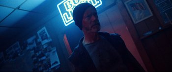 Movie still from “VFW” (2019), directed by Joe Begos – A man with a beard wearing a black hat; Close Up shot, Low angle