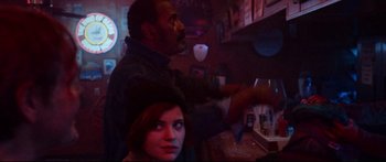 Movie still from “VFW” (2019), directed by Joe Begos – A man and a woman at a bar; Medium shot, Over the shoulder angle