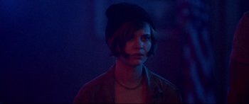 Movie still from “VFW” (2019), directed by Joe Begos – A person with a hat in a dark room; Close Up shot, Over the shoulder angle