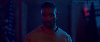 Movie still from “VFW” (2019), directed by Joe Begos – A person in a dark room; Close Up shot, Low angle