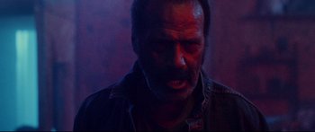 Movie still from “VFW” (2019), directed by Joe Begos – A person with a face covered in blood; Close Up shot, Low angle