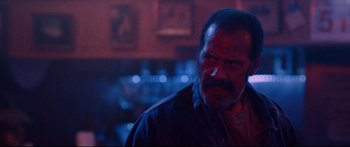 Movie still from “VFW” (2019), directed by Joe Begos – A person wearing a jacket; Close Up shot, Low angle