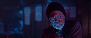 Movie still from “VFW” (2019), directed by Joe Begos – An old man with a red beard and a black hat; Close Up shot, Low angle