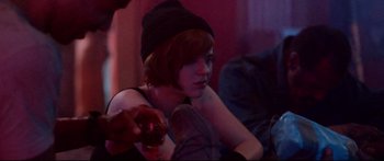 Movie still from “VFW” (2019), directed by Joe Begos – A woman in a black hat is holding a glass of wine; Close Up shot, Over the shoulder angle