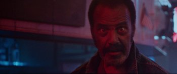 Movie still from “VFW” (2019), directed by Joe Begos – A person looking at the camera; Close Up shot, Low angle