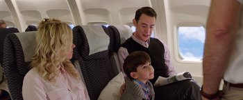 Movie still from “Vacation” (2015), directed by John Francis Daley – A man sitting next to a little boy on a plane; Medium shot, High angle