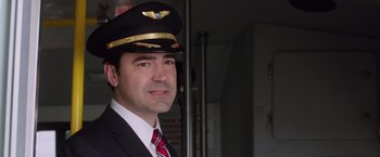 Movie still from “Vacation” (2015), directed by John Francis Daley – A man in a suit and tie wearing a pilot's hat; Close Up shot, Low angle