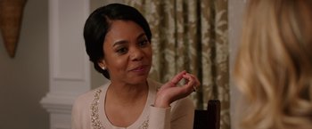 Movie still from “Vacation” (2015), directed by John Francis Daley – A woman sitting at a table in front of a curtain; Close Up shot, Over the shoulder angle