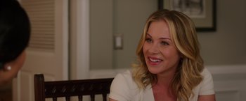 Movie still from “Vacation” (2015), directed by John Francis Daley – A woman sitting in front of a mirror smiling for the camera; Close Up shot, Over the shoulder angle