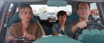 Movie still from “Vacation” (2015), directed by John Francis Daley – A group of people sitting in the back of a car; Medium shot, Over the shoulder angle